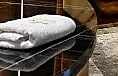 Fresh rolled linen on a marble counter at the reception desk.